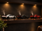 Three Aromotors car diffusers on a shelf like a car collection